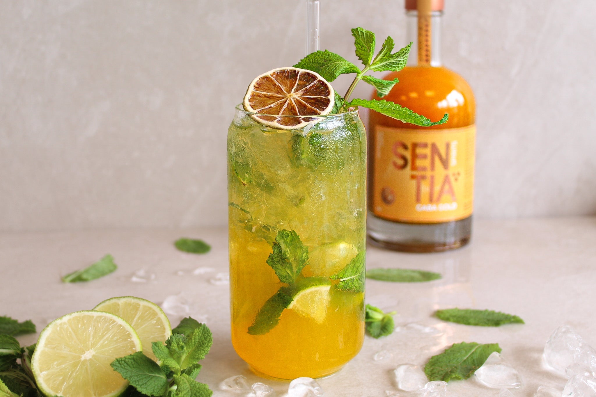 Image of the Mojito with a bottle of Sentia Gold in the background